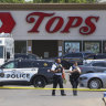 Police walk outside the Tops grocery store after the shooting in Buffalo, New York last month.