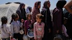 Displaced Palestinians line up to receive donated meals from a community kitchen in Gaza City on May 21.