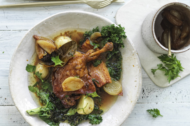 Braised duck with bacon, prunes and kale.