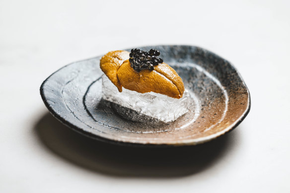 Sea urchin and caviar on transparent crystal bread.