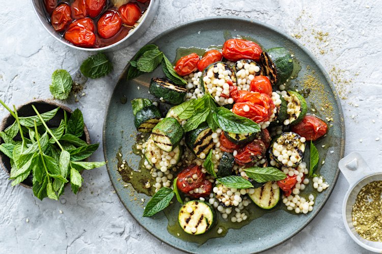 Hetty McKinnon's grilled zucchini, zaatar and pearl cous cous salad with cherry tomato confit.