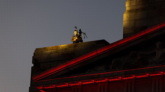 A lone bagpiper welcomed the dawn from the roof of the Shrine.
