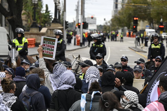 Pro-Palestine protesters were held back by police to stop them approaching a pro-Israel protest.
