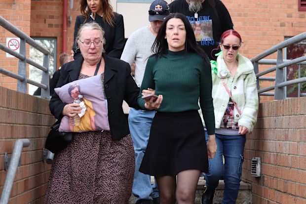 Mother of Zane Mellor, Georgie Burt (centre right) is seen outside the Devonport Magistrates Court in Devonport in June 2025.