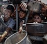 Palestinians, including children, line up this week in Gaza City to receive food.  