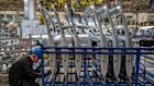 A worker checks parts at a Zeekr EV factory in China. 