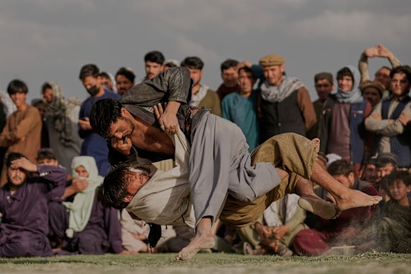 Afghans wrestlers fight during a match at the Chaman-e-Hozari Park in Kabul, Afghanistan.