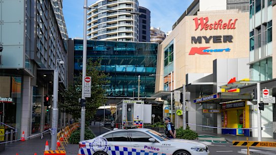 A police officer stands at police cordon near a crime scene at Bondi Junction in Sydney, Monday, April 15, 2024, after several people were stabbed to death at a shopping, Saturday April 13. Australian police are examining why a lone assailant who stabbed multiple people to death in a busy Sydney shopping mall and injured more than a dozen others targeted women while avoiding men. (AP Photo/Mark Baker)