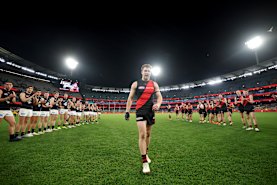 Zach Merrett of the Bombers walks off the ground following his 250th game.