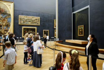 Visitors take in Leonardo da Vinci’s Mona Lisa at Louvre Museum in Paris in July 2020.