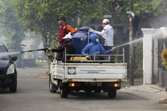 A street in Tangerang, near Jakarta in Indonesia, is sprayed with disinfectant to try to stop the spread of coronavirus.