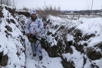 A Ukrainian serviceman stands in a trench in an area controlled by pro-Russian militants in Ukraine’s east.