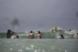 Bathers take refuge from the heat at Maroubra beach on Sunday afternoon. 