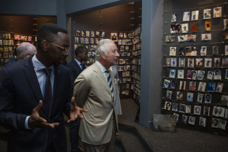 Prince Charles looks at photographs of some of those who died, at the Kigali Genocide Memorial in Kigali, Rwanda.