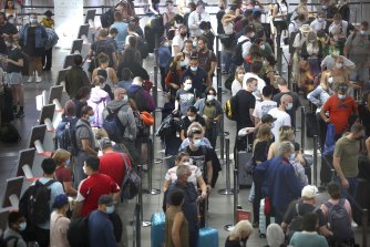 Domestic passengers endure long queues at Sydney Airport early on Saturday afternoon.