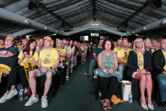 United Australia Party supporters watch a big-screen replay of chairman Clive Palmer’s recent National Press Club speech while they wait for his arrival.