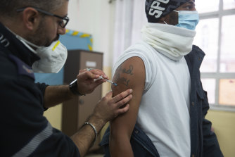 A medic with the Magen David Adom emergency service administers a dose of the Pfizer-BioNTech COVID-19 vaccine during a one-day clinic at a school near the Al Aqsa Mosque compound to vaccinate worshippers following Friday prayers in the Old City of Jerusalem. 