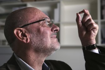 Professor Timothy Flannery studies one of the tiny monotreme fossils in the Australian Museum’s collection.