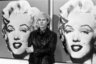 Andy Warhol in front of a double portrait of Marilyn Monroe at the Tate Gallery in 1971. 