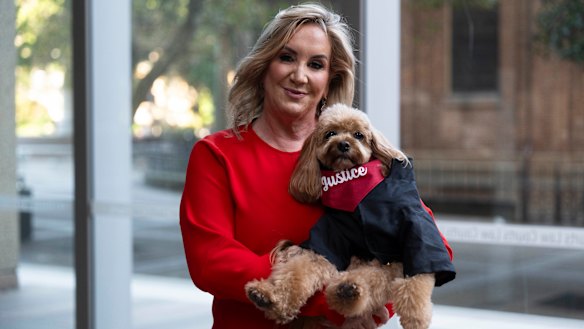 Gina Edwards and Oscar the cavoodle after she won her defamation case against Nine.