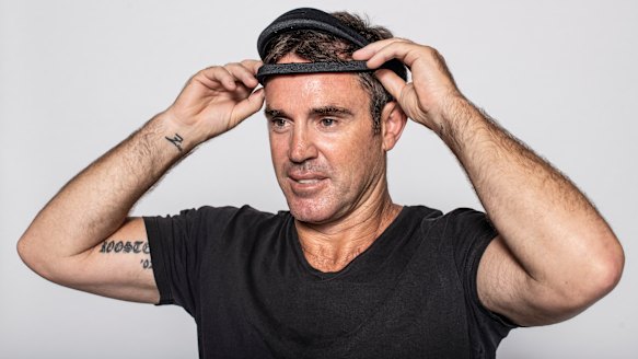 NSW coach Brad Fittler tries on the Dreem sleep assessment headband.
