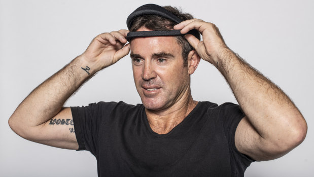 NSW coach Brad Fittler tries on the Dreem sleep assessment headband.