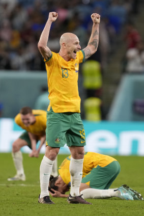 Aaron Mooy and the Socceroos celebrate victory.
