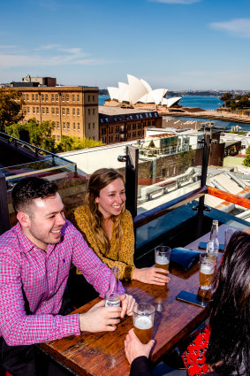 Patrons enjoying Sydney's warm weather on the rooftop of the Glenmore Hotel.