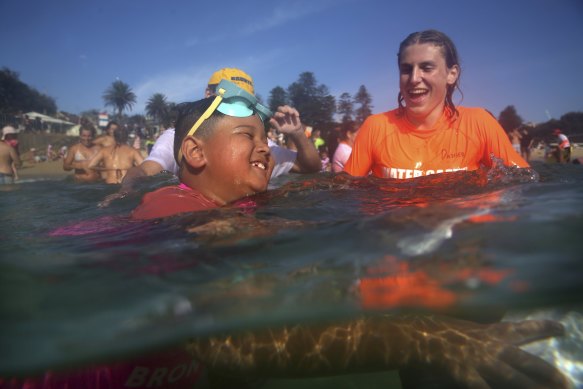 Ollie in the water with a Bronte Surf Life Savers Club member at a Nippers training day.