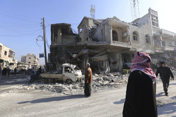 People gather in the the market in the city of Saraqeb in the Idlib countryside after an air strike by Syrian aircraft on December 21.