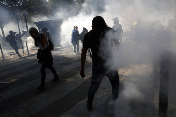Protesters enveloped by tear gas during the climate demonstration in Paris.