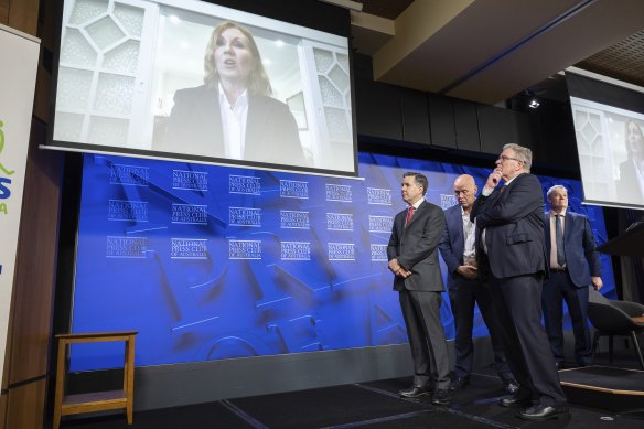 Adele Ferguson accepts her Health Journalist of the Year award via a video message with Health Minister Mark Bulter (right) watching on.