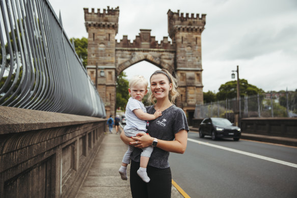 Castlecrag resident Frankie Nicklin, with Roman Ellis, 1, says the castle-themed Long Gully Bridge is charming. 