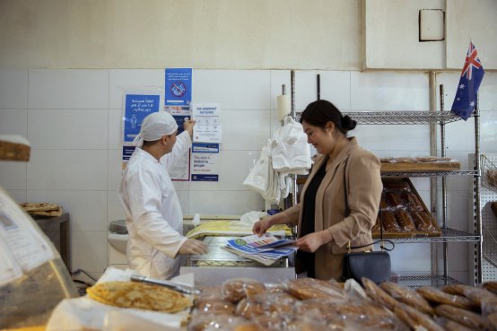 Baker Abdullah Khadim Hussain and NSW Health multicultural worker Fouzia Hamdard reconfigured Auburn’s Traditional Afghan Bakery after other local businesses received public health order fines.