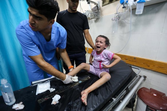 Palestinians injured in Israeli air raids arrive at Nasser Medical Hospital in Gaza.