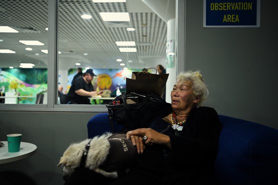 Ayesha Kazan and her dog Yuhu in the observation area after Ms Kazan received her COVID-19 vaccine.