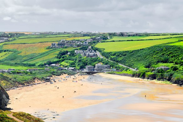 Holiday makers on the sandy beach at Mawgan Porth, Cornwall, England, where Cate Blanchett’s new house build has angered some locals. 
