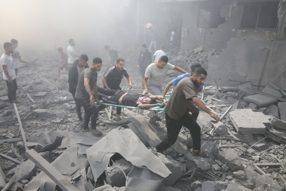 Palestinians evacuate wounded people after an Israeli airstrike in the Rafah refugee camp.