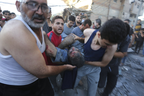 Palestinians evacuate survivors after an Israeli strike on the Gaza Strip.