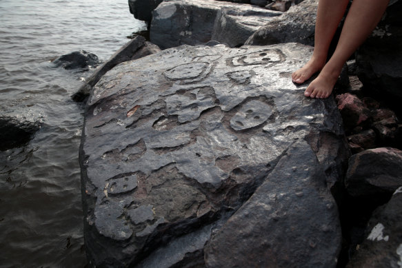 Ancient stone carvings on a rocky point of the Amazon River exposed after water levels dropped to record lows during a drought in Manaus, Brazil.