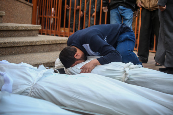 A man mourns as he collects the body of a Palestinian killed in an airstrike on Khan Yunis on Wednesday.