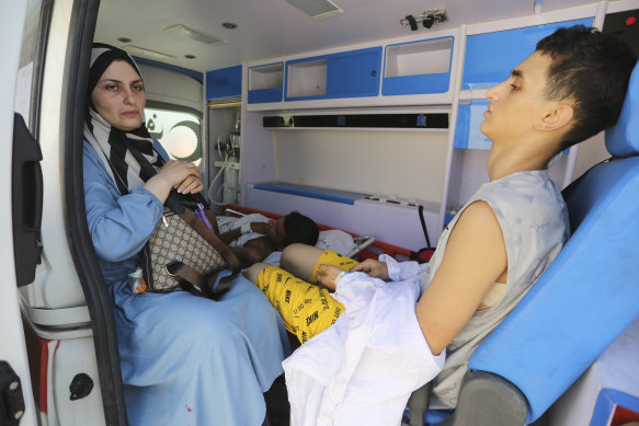 Palestinian ambulances with people wounded in the Israeli bombing of the Gaza Strip arrive at the border crossing.