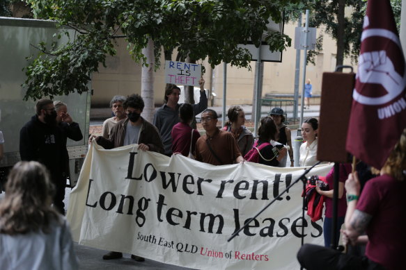 Protesters outside the Queensland housing summit call for a boost to tenants’ rights and an end to “predatory” rent increases.
