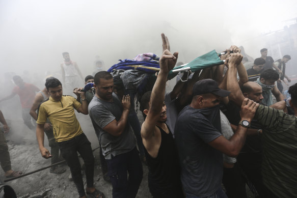 Palestinians remove a dead body from the rubble of a building after an Israeli airstrike in Jebaliya refugee camp on the Gaza Strip.