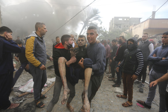 Palestinians evacuate survivors of an Israeli strike in Rafah, Gaza Strip.