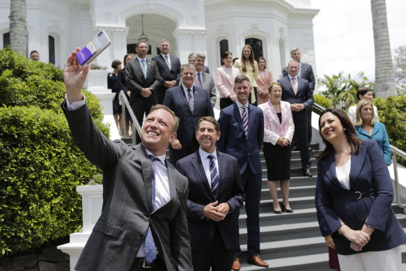 Deputy Premier Steven Miles wrangles his newly sworn-in cabinet colleagues for a selfie at Government House after the 2020 election. At least three faces will no longer feature after Friday – most significantly Annastacia Palaszczuk.