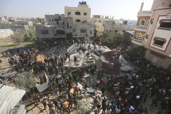 Palestinians look for survivors after an Israeli strike on the Gaza Strip in Rafah, November 23.