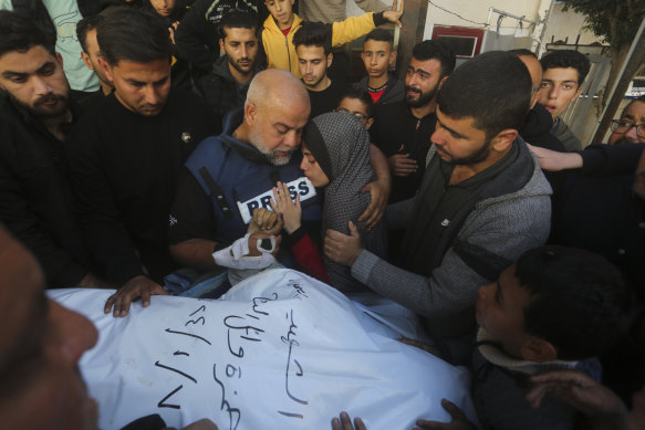 Al Jazeera journalist Wael Dahdouh holds the hand of his son Hamza, who also worked for Al Jazeera and who was killed in an Israeli airstrike in Rafah, Gaza Strip.