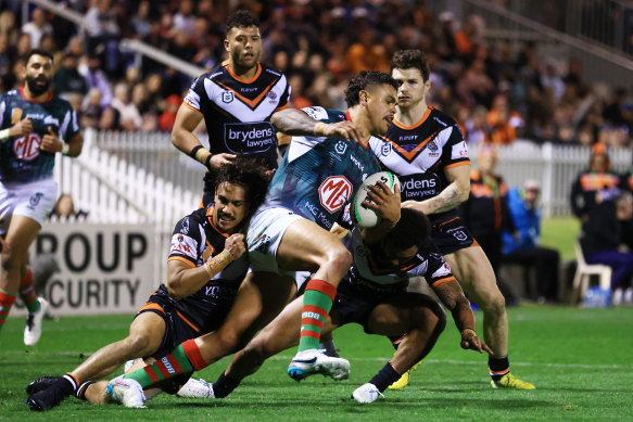 Latrell Mitchell is tackled by several Tigers in Tamworth.