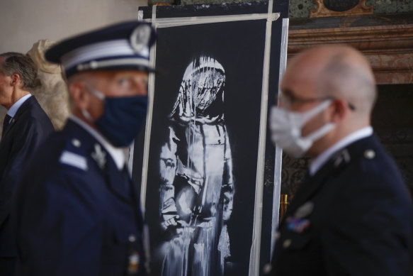The recovered stolen artwork by British artist Banksy during the handover ceremony at the French Embassy in Rome.
